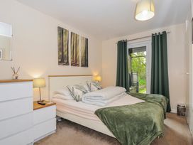 A bedroom with a bed and dresser at Hideaway Cottage St Ann's Chapel, Cornwall