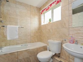 A bathroom with a bathtub, toilet, and sink at Hideaway Cottage in St Ann's Chapel, Cornwall