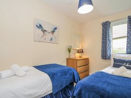 A bedroom with two beds and a dresser at Hideaway Cottage St Ann's Chapel Cornwall
