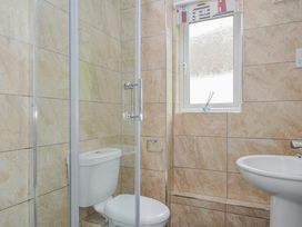 A bathroom with a shower, toilet, and sink at Hideaway Cottage, St Ann's Chapel, Cornwall