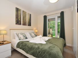 A bedroom with a bed and a door leading outside at Hideaway Cottage St Ann's Chapel, Cornwall