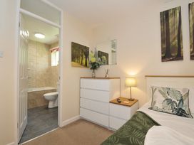 A bedroom with a bed and dresser at Hideaway Cottage, St Ann's Chapel, Cornwall