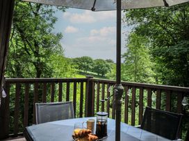 A table with drinks and pastries on a balcony at Hideaway Cottage, St Ann's Chapel, Cornwall