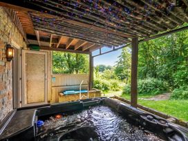 A hot tub on an outdoor terrace at Hideaway Cottage St Ann's Chapel, Cornwall