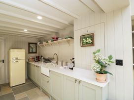 A kitchen with a yellow fridge and a sink at Mallards in Bourton-On-The-Water