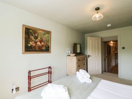 A bedroom with a bed and dresser at Mallards in Bourton-On-The-Water