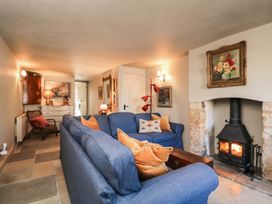 A living room with a sofa and fireplace at Mallards in Bourton-On-The-Water