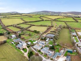 An aerial view of farmland and houses at Middle Dean Farmhouse in Trentishoe near Parracombe