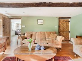 A living room with a sofa and coffee table at Middle Dean Farmhouse in Trentishoe near Parracombe