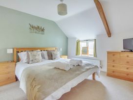 A bedroom with a bed and chest of drawers at Middle Dean Farmhouse in Trentishoe near Parracombe
