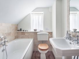 A bathroom with a bathtub, sink, and toilet at Middle Dean Farmhouse in Trentishoe near Parracombe