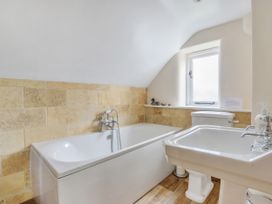 A bathroom with a bathtub, sink, and toilet at Middle Dean Farmhouse near Trentishoe