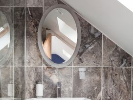 A bathroom with a mirror and sink at Middle Dean Farmhouse in Trentishoe near Parracombe