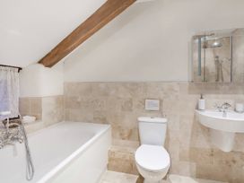 A bathroom with a bathtub and a shower at Middle Dean Farmhouse Trentishoe near Parracombe