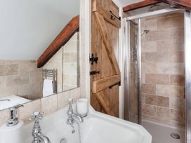 A bathroom with a bathtub and shower at Middle Dean Farmhouse Trentishoe near Parracombe