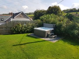 A hot tub with steps in a garden at Middle Dean Farmhouse near Parracombe