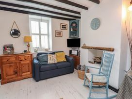 A living room with a sofa and a coffee table at Menuchah in Criccieth