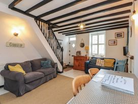 A living room with a sofa and table at Menuchah in Criccieth