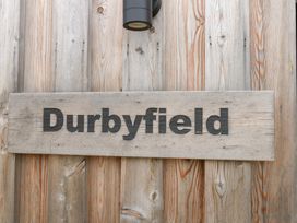 A wooden sign displaying the name Durbyfield in Nottington near Weymouth