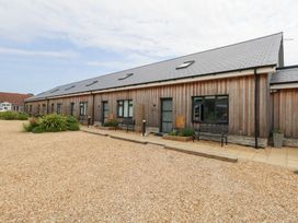 A wooden building with benches and gravel area at Durbyfield Nottington near Weymouth