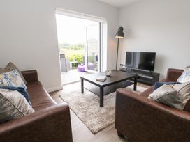 A living room with a coffee table and television at Durbyfield Nottington near Weymouth