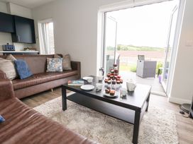 A living room with cupcakes on a table at Durbyfield in Nottington near Weymouth