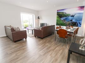 A living room with sofas and a dining area at Durbyfield in Nottington near Weymouth