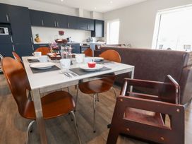 A kitchen with a dining table and chairs at Durbyfield in Nottington near Weymouth