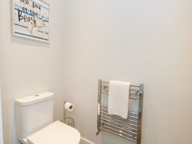 A bathroom with a toilet and towel rack at Durbyfield in Nottington near Weymouth