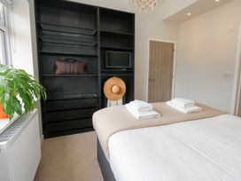 A bedroom with a bed, towels on the bed, and a plant at Durbyfield, Nottington near Weymouth