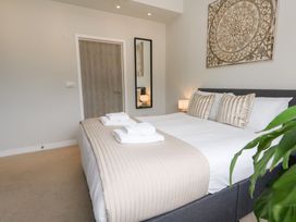 A bedroom with a bed and lamp at Durbyfield in Nottington near Weymouth