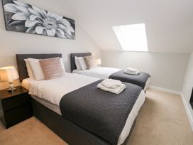 A bedroom with two beds and a lamp at Durbyfield Nottington near Weymouth