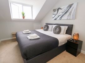 A bedroom with a double bed and a window at Durbyfield in Nottington near Weymouth