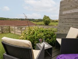 An outdoor seating area with chairs and a table at Durbyfield Nottington near Weymouth