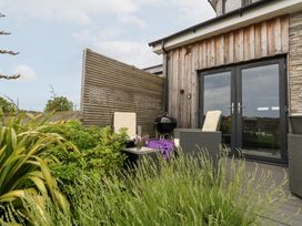 An outdoor area with chairs and a table at Durbyfield in Nottington near Weymouth