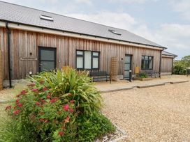 An outdoor view of a building with plants at Egdon Heath in Nottington near Weymouth