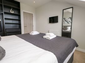 A bedroom with a bed and towels at Durbyfield in Nottington near Weymouth