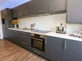 A kitchen with cabinets, sink, stove, oven and toaster at Overcombe Mill in Nottington near Weymouth