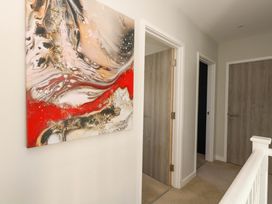 A hallway with artwork on the wall at Overcombe Mill in Nottington near Weymouth