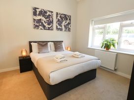 A bedroom with a bed and bedside tables at Overcombe Mill Nottington near Weymouth