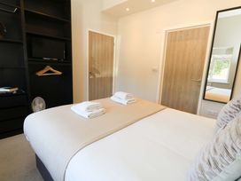 A bedroom with a bed and television at Overcombe Mill Nottington near Weymouth