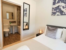 A bedroom with a bed and an ensuite bathroom at Overcombe Mill near Weymouth