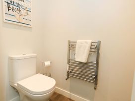 A bathroom with a toilet and towel radiator at Overcombe Mill in Nottington near Weymouth