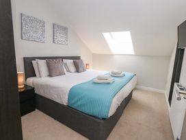 A bedroom with a bed and art on the wall at Overcombe Mill Nottington near Weymouth