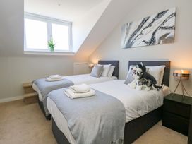 A bedroom with two beds and stuffed animals at Overcombe Mill Nottington near Weymouth