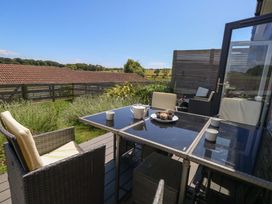An outdoor dining area with a table and chairs at Overcombe Mill in Nottington near Weymouth