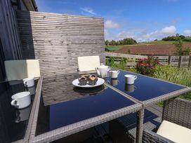 An outdoor seating area with a table and chairs at Overcombe Mill Nottington near Weymouth