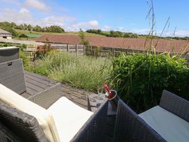 An outdoor area with seating and plants at Overcombe Mill in Nottington near Weymouth