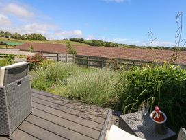 A patio area with a chair and champagne bottle at Overcombe Mill Nottington near Weymouth