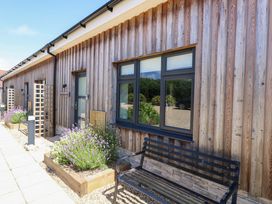 An outdoor area with a wooden facade and plants at Overcombe Mill Nottington near Weymouth